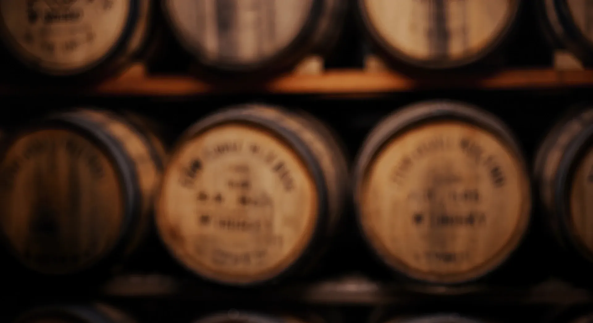 Rows of oak whisky casks maturing in a dimly lit warehouse